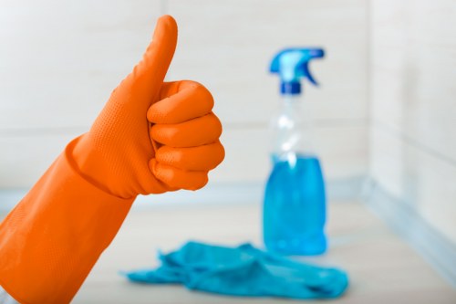 Professional cleaner using PPE during a routine cleaning task